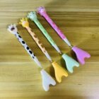Pack of 4 giraffe-themed blue ink gel pens for kids – animal-shaped pens ideal for school use and birthday return gift ideas.